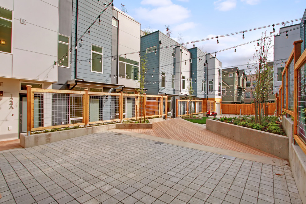 This is an example of a modern front yard patio in Seattle with concrete slab.