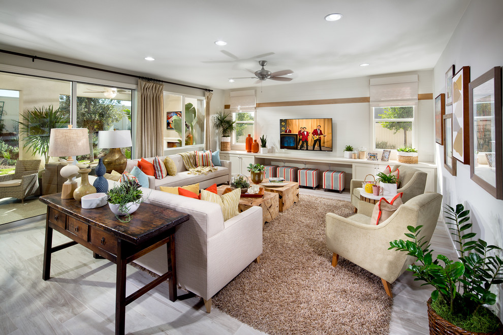 This is an example of a mediterranean formal living room in Orange County with white walls, no fireplace and a wall-mounted tv.