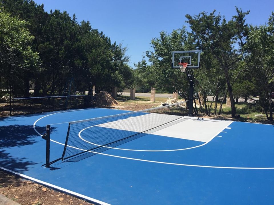 Mid-sized traditional backyard partial sun outdoor sport court in Austin with with outdoor playset and concrete pavers for summer.