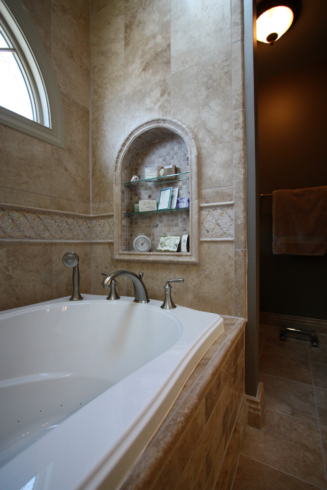 Mid-sized mediterranean master bathroom in Richmond with an undermount sink, raised-panel cabinets, granite benchtops, a drop-in tub, an alcove shower, a two-piece toilet, beige tile, stone tile, grey walls and travertine floors.