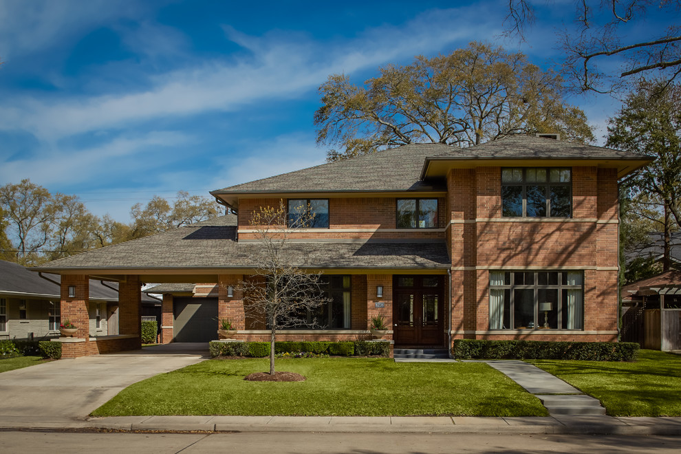 Large contemporary two-storey brick exterior in Houston with a hip roof.