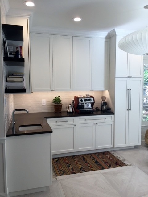 Photo of a large contemporary u-shaped open plan kitchen in New Orleans with an undermount sink, shaker cabinets, white cabinets, quartz benchtops, white splashback, ceramic splashback, panelled appliances, ceramic floors, a peninsula and grey floor.