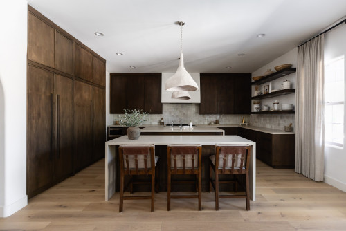 Wabi-sabi kitchen cabinets in Canada — dark walnut cabinetry, minimalist island, open shelves, ceramic pendant lights