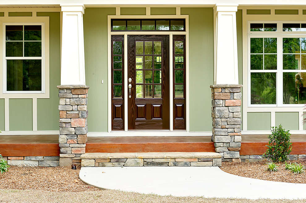 Example of an arts and crafts entry hall design with a dark wood front door