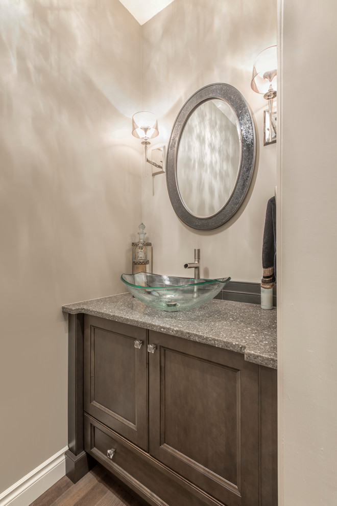 Transitional powder room in Edmonton with distressed cabinets, beige walls, medium hardwood floors, a vessel sink and terrazzo benchtops.