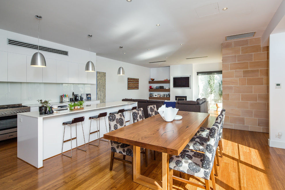 Photo of a contemporary open plan dining in Adelaide with white walls, medium hardwood floors and no fireplace.