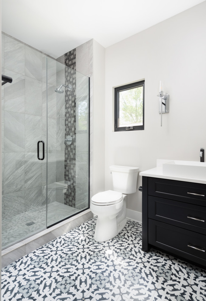 Mid-sized country kids bathroom in Chicago with shaker cabinets, black cabinets, an alcove shower, a two-piece toilet, gray tile, grey walls, porcelain floors, an integrated sink, grey floor, a hinged shower door, white benchtops, a single vanity and a built-in vanity.