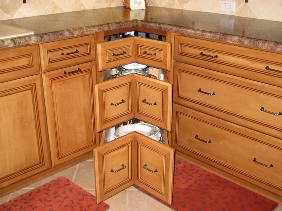 Photo of a mid-sized traditional kitchen in Phoenix with raised-panel cabinets, medium wood cabinets, granite benchtops and travertine floors.