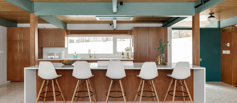 Medium sized retro kitchen/diner in Minneapolis with a submerged sink, flat-panel cabinets, brown cabinets, engineered stone countertops, white splashback, engineered quartz splashback, integrated appliances, terrazzo flooring, an island, white floors, white worktops and exposed beams.