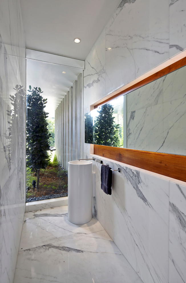 Photo of a contemporary powder room in Singapore with marble floors and marble.
