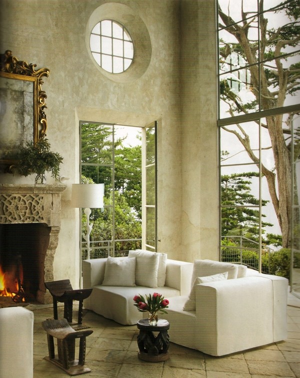 Photo of a large mediterranean formal open concept living room in Los Angeles with multi-coloured walls, limestone floors, a standard fireplace, a stone fireplace surround and no tv.