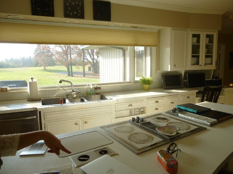 This is an example of a large traditional galley separate kitchen in Detroit with flat-panel cabinets, white cabinets, laminate benchtops and with island.