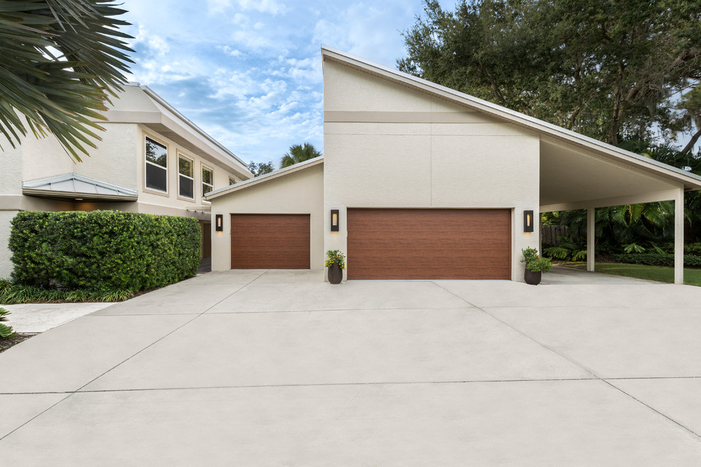 This is an example of a large transitional two-storey concrete beige exterior in Tampa.