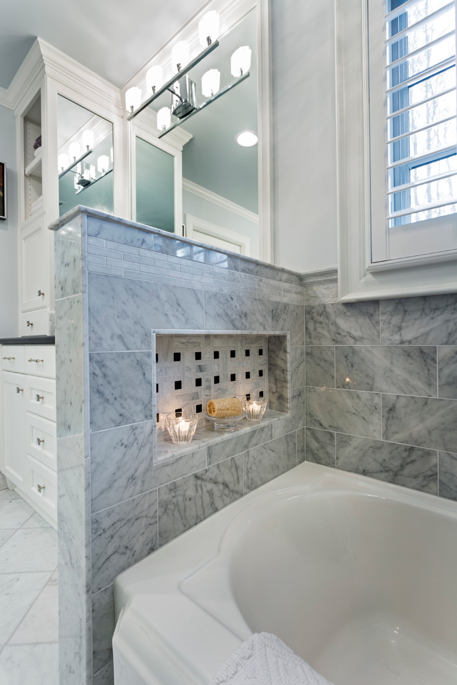 Mid-sized transitional master bathroom in Charlotte with an undermount sink, recessed-panel cabinets, white cabinets, granite benchtops, an alcove tub, an alcove shower, a two-piece toilet, white tile, stone slab, grey walls and marble floors.
