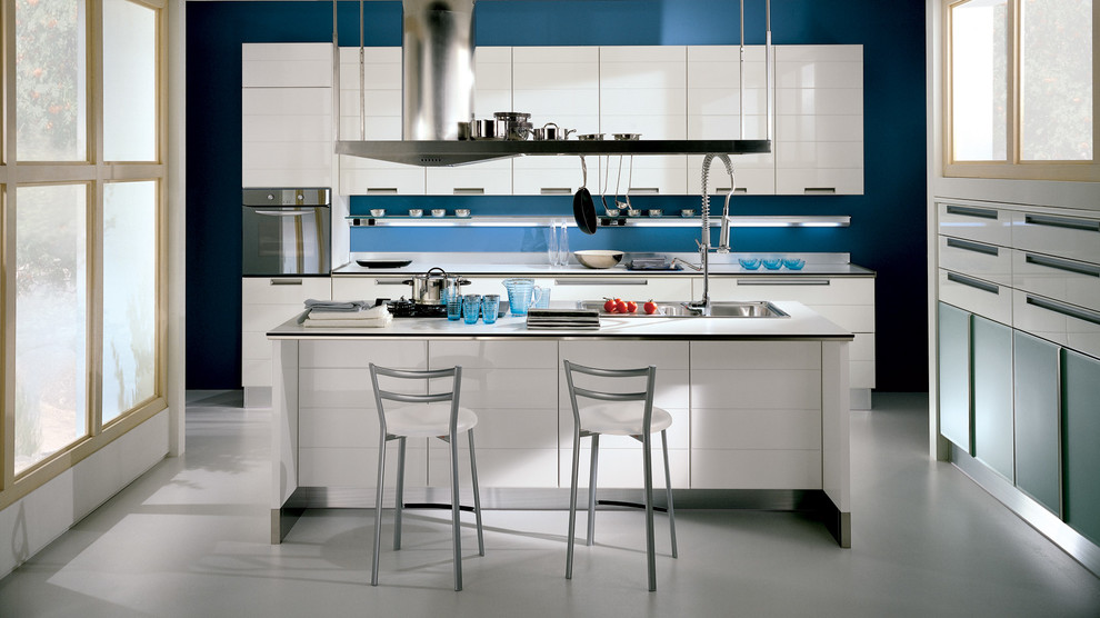 Inspiration for a small modern l-shaped eat-in kitchen in Melbourne with a double-bowl sink, raised-panel cabinets, white cabinets, quartz benchtops, blue splashback, glass sheet splashback, black appliances, ceramic floors and multiple islands.
