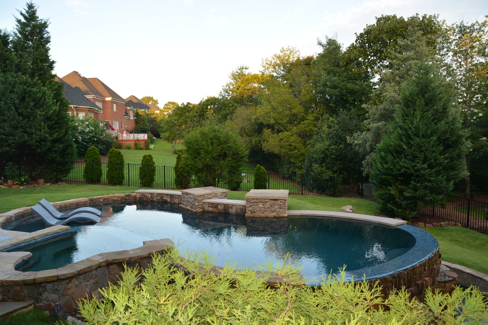 Inspiration for a mid-sized craftsman backyard tile and custom-shaped infinity pool fountain remodel