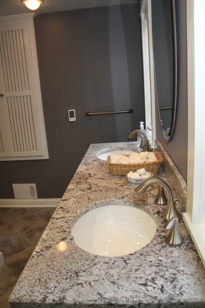 Design ideas for a mid-sized transitional bathroom in New York with white cabinets, a two-piece toilet, ceramic tile, ceramic floors, an undermount sink, granite benchtops, purple walls, gray tile, an alcove tub and a shower/bathtub combo.