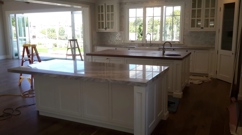 Open concept kitchen - huge open concept kitchen idea in Orange County with two islands