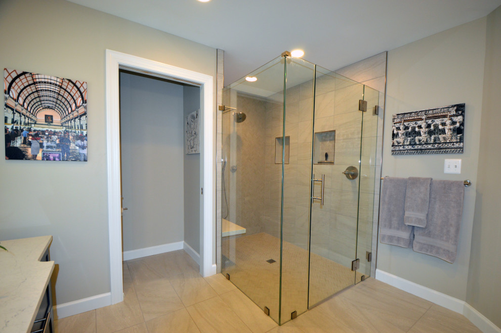 This is an example of a large traditional ensuite bathroom in DC Metro with flat-panel cabinets, grey cabinets, a built-in shower, a two-piece toilet, white tiles, porcelain tiles, grey walls, porcelain flooring, a submerged sink, engineered stone worktops, white floors, a hinged door, white worktops, a shower bench, double sinks and a built in vanity unit.