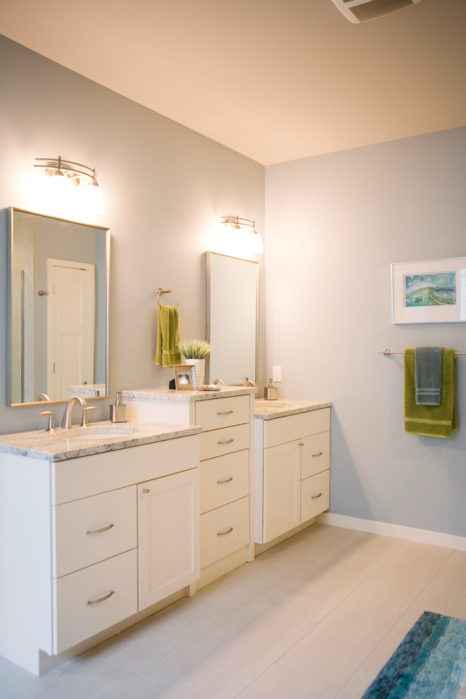 Photo of a mid-sized transitional master bathroom in Milwaukee with flat-panel cabinets, white cabinets, granite benchtops, blue walls and porcelain floors.