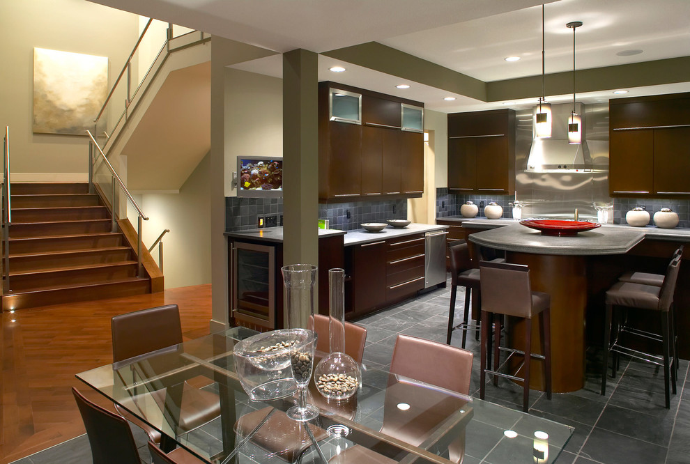 Inspiration for a large transitional u-shaped ceramic tile eat-in kitchen remodel in Phoenix with flat-panel cabinets, medium tone wood cabinets, quartz countertops, blue backsplash, glass tile backsplash, stainless steel appliances and an island