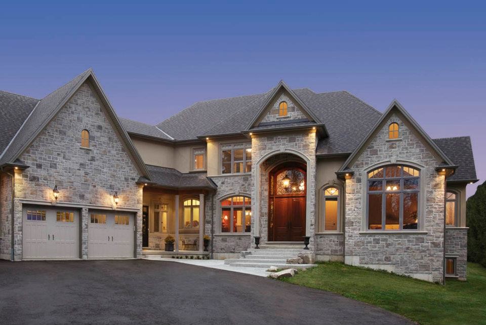 Inspiration for a large traditional two-storey grey exterior in Toronto with mixed siding.
