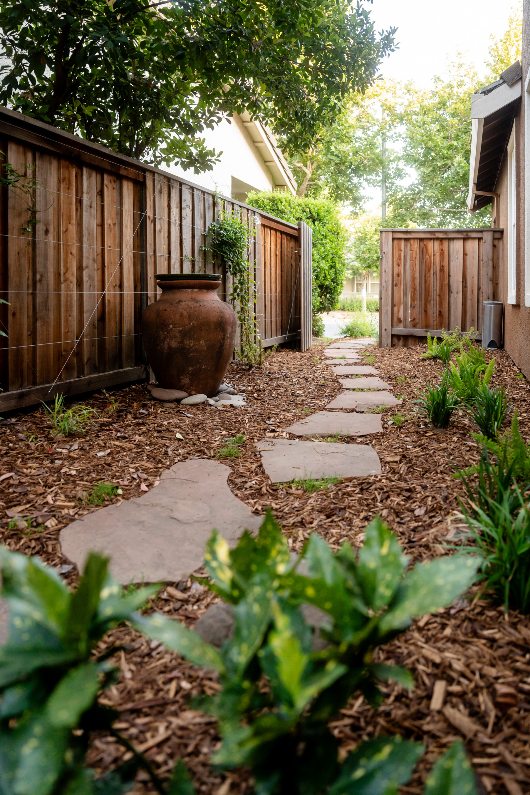 Reimagined Side Yard with Reused Materials and Sculptural Focal Point