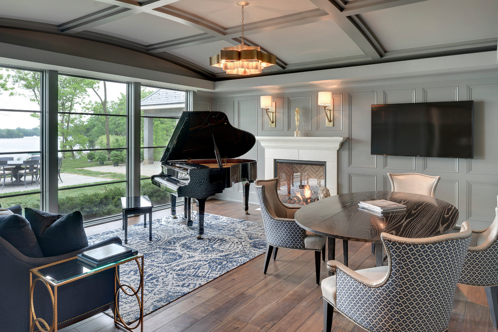 Inspiration for a large contemporary enclosed family room in Minneapolis with a music area, grey walls, carpet, a standard fireplace, a stone fireplace surround and a wall-mounted tv.