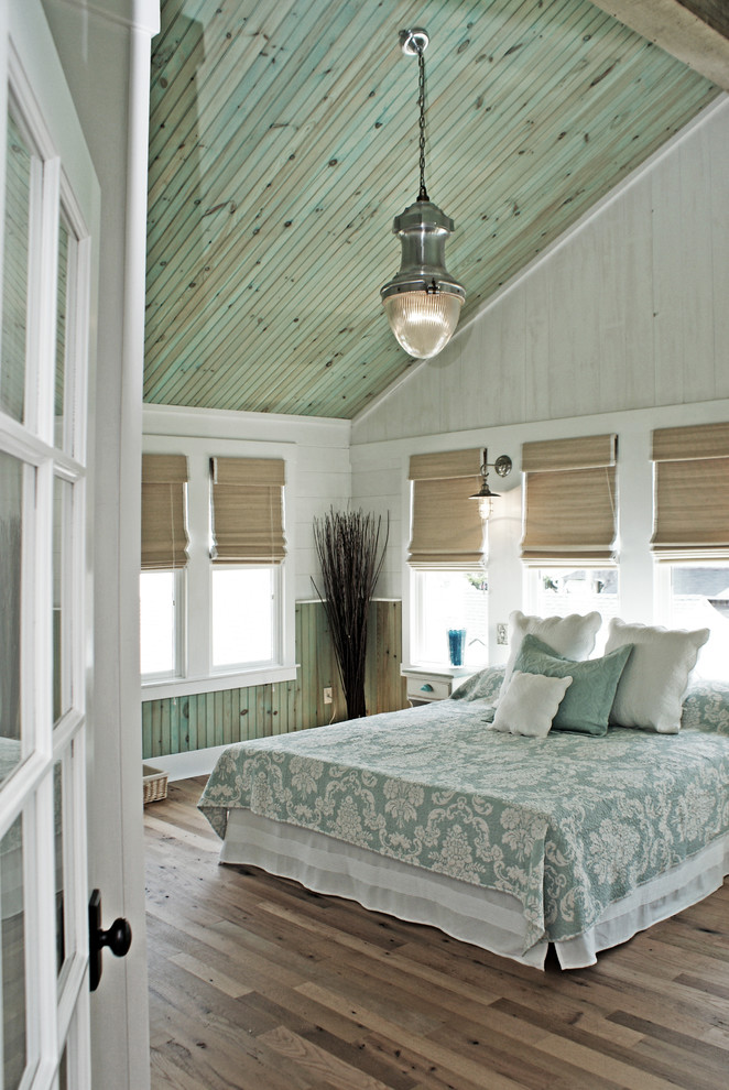 Inspiration for a beach style master bedroom in DC Metro with multi-coloured walls and light hardwood floors.