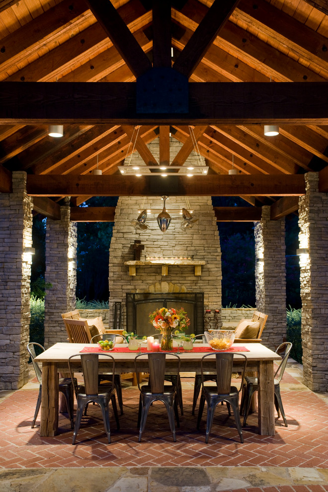 Traditional patio in Dallas with brick pavers and with fireplace.