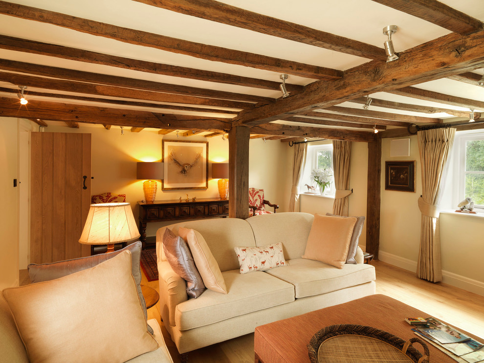 Design ideas for a large rural formal open plan living room in Hampshire with beige walls and light hardwood flooring.