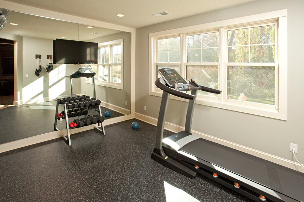 This is an example of a mid-sized country home weight room in Minneapolis with grey walls.