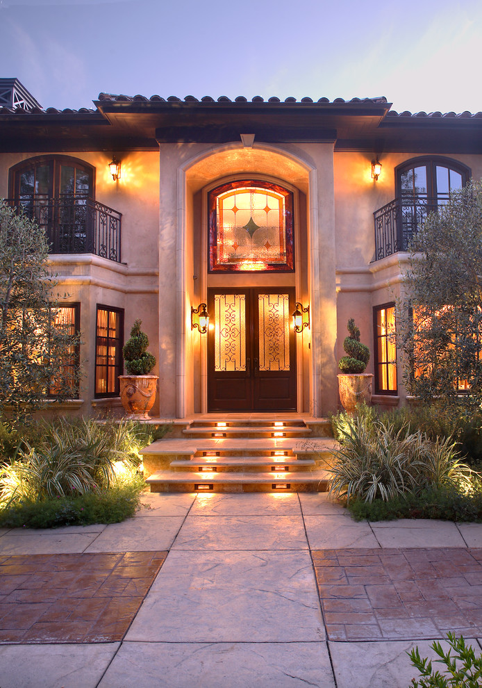 Design ideas for an expansive mediterranean front door in Los Angeles with beige walls, a double front door and a dark wood front door.