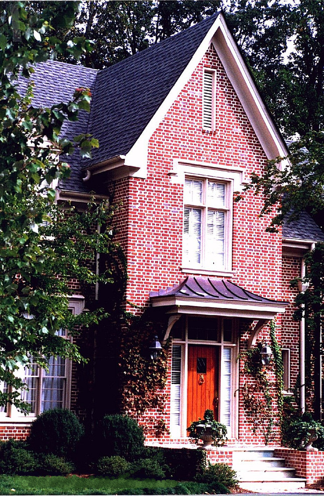 Design ideas for a mid-sized traditional two-storey brick red exterior in Atlanta with a gable roof.