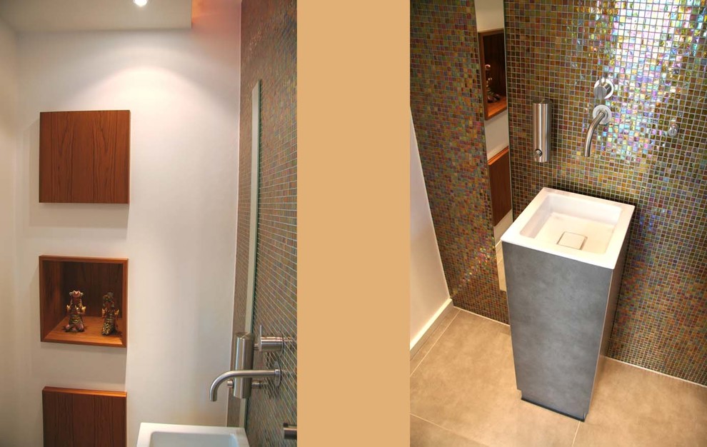 Small modern bathroom in Cologne with an integrated sink, flat-panel cabinets, medium wood cabinets, a wall-mount toilet, gray tile, mosaic tile, white walls and ceramic floors.
