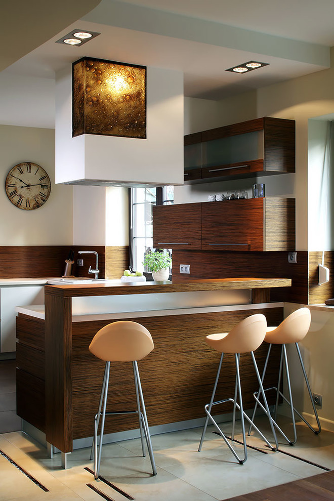 Inspiration for a contemporary u-shaped seated home bar in Other with flat-panel cabinets, dark wood cabinets and brown splashback.