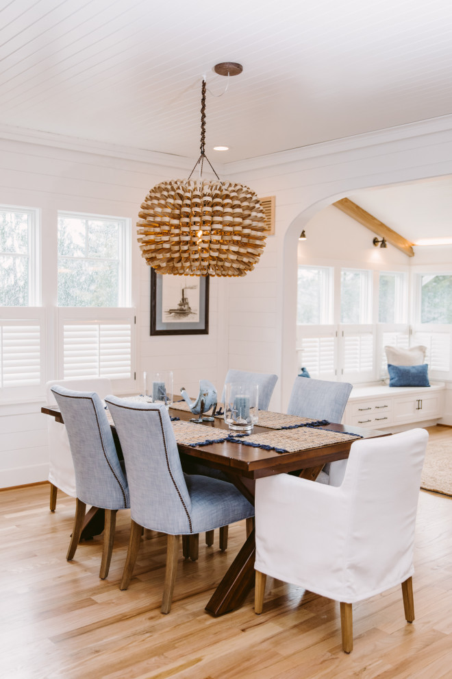 Inspiration for a beach style separate dining room in Baltimore with white walls, medium hardwood floors, no fireplace, brown floor and timber.