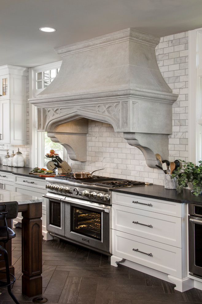 Inspiration for an expansive traditional l-shaped separate kitchen in Cincinnati with an undermount sink, beaded inset cabinets, white cabinets, granite benchtops, multi-coloured splashback, stainless steel appliances, porcelain floors and a peninsula.