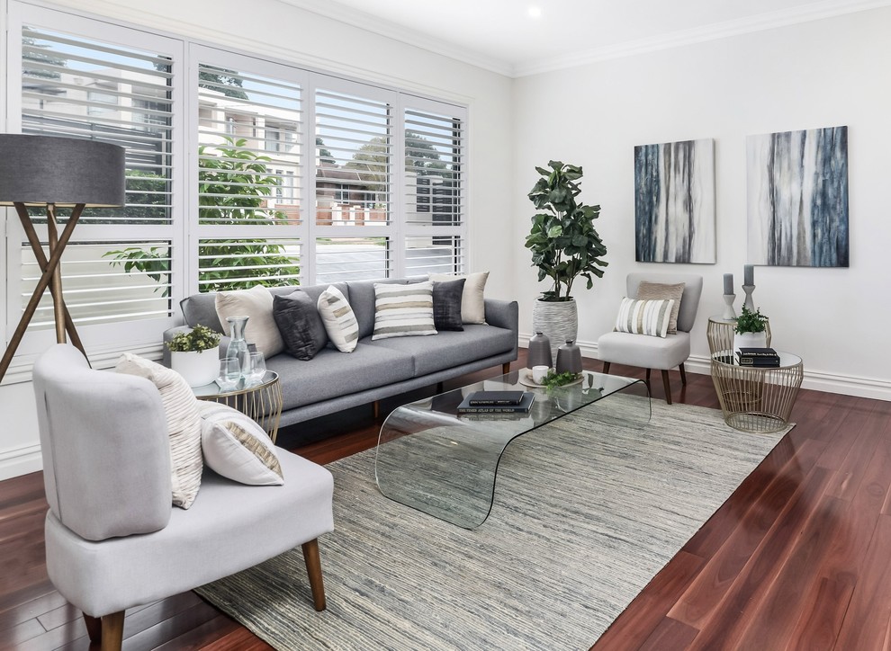 Transitional living room in Sydney with white walls, medium hardwood floors and brown floor.