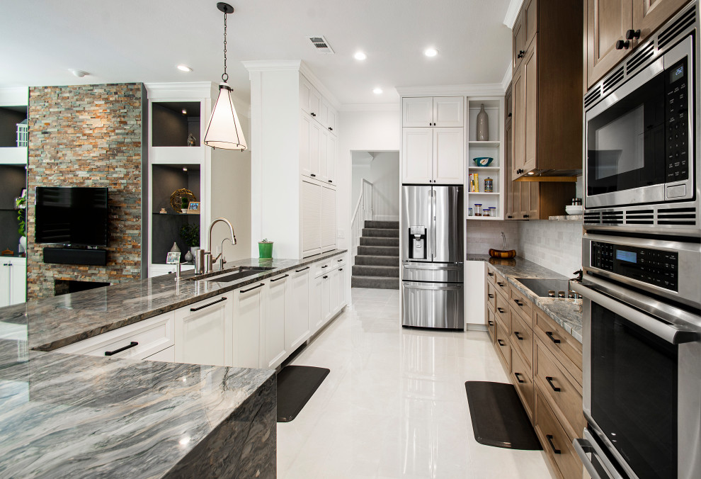 Inspiration for a mid-sized modern galley eat-in kitchen in Dallas with an undermount sink, flat-panel cabinets, brown cabinets, quartzite benchtops, white splashback, stainless steel appliances, porcelain floors, a peninsula, white floor and grey benchtop.