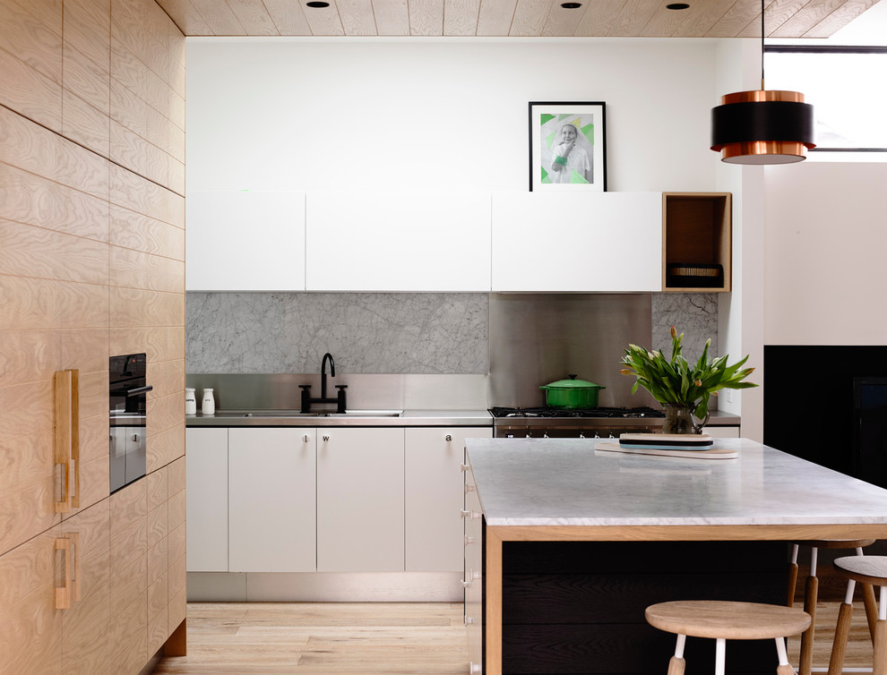 Contemporary kitchen in Melbourne with marble benchtops.