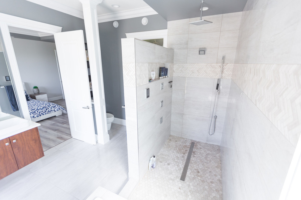 Inspiration for a transitional master beige tile beige floor bathroom remodel with flat-panel cabinets, medium tone wood cabinets, gray walls and a vessel sink
