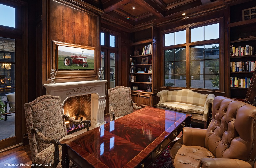 Design ideas for a traditional study room in Phoenix with medium hardwood floors, a standard fireplace, a stone fireplace surround and a freestanding desk.