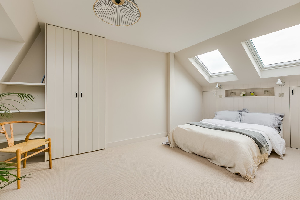 Design ideas for a mid-sized scandinavian guest bedroom in London with beige walls, carpet and beige floor.