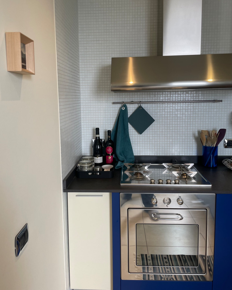 Photo of a mid-sized contemporary galley eat-in kitchen in Other with a drop-in sink, flat-panel cabinets, turquoise cabinets, quartz benchtops, white splashback, mosaic tile splashback, stainless steel appliances, porcelain floors, with island, beige floor and grey benchtop.