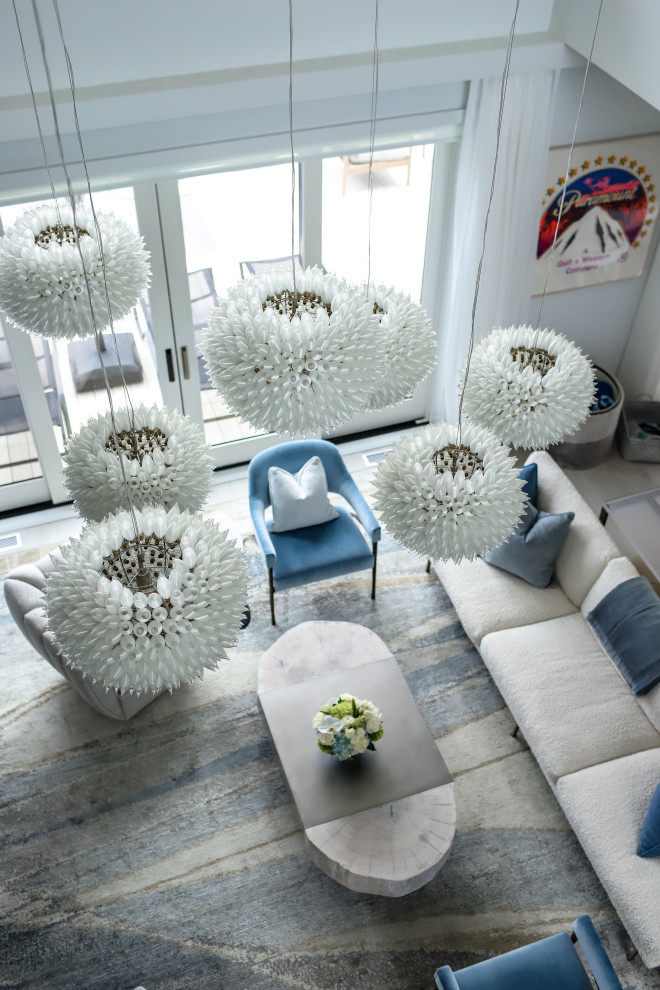 This is an example of a medium sized beach style living room in New York with grey walls and carpet.