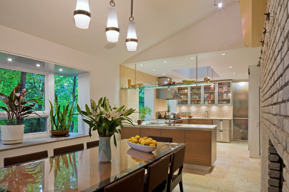 This is an example of a mid-sized contemporary u-shaped eat-in kitchen in New York with flat-panel cabinets, light wood cabinets, multi-coloured splashback, stainless steel appliances and a peninsula.