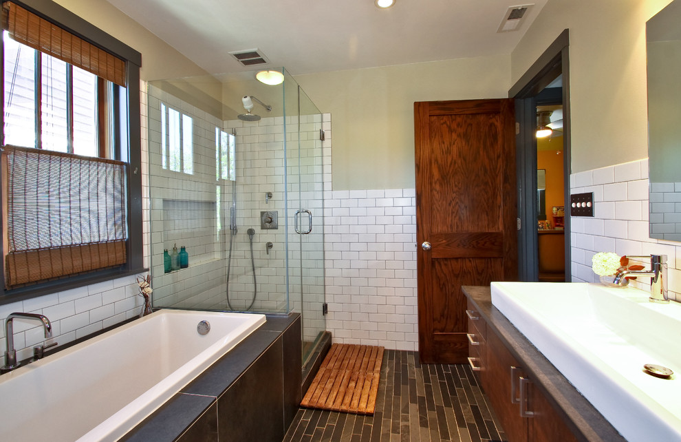 Small transitional master bathroom in Chicago with a trough sink, flat-panel cabinets, dark wood cabinets, concrete benchtops, a drop-in tub, a corner shower, a two-piece toilet, white tile, subway tile, white walls and slate floors.