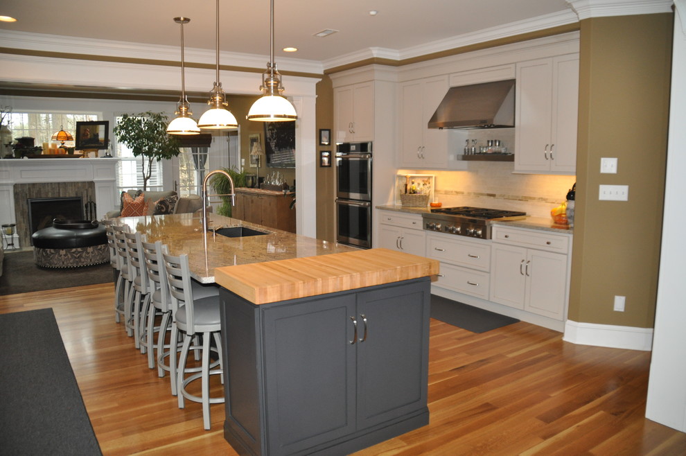 Large transitional light wood floor eat-in kitchen photo in Baltimore with an undermount sink, flat-panel cabinets, gray cabinets, granite countertops, gray backsplash, stainless steel appliances, an island and multicolored countertops