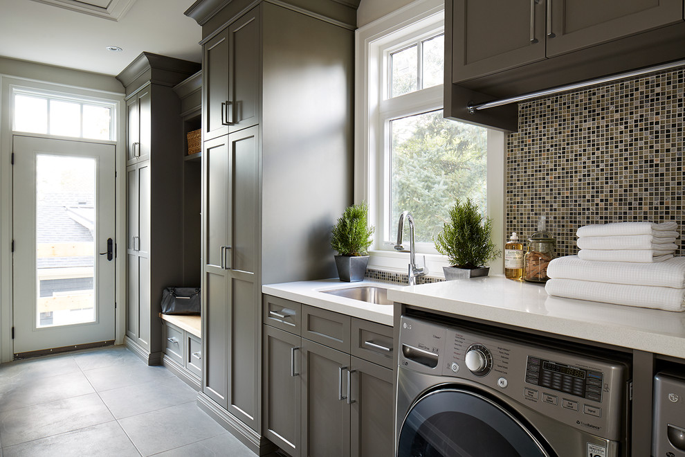 Inspiration for a transitional single-wall utility room in Toronto with an undermount sink, shaker cabinets, brown cabinets, a side-by-side washer and dryer and grey walls.